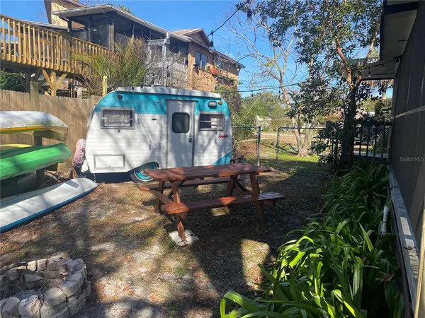 a view of a house with backyard and sitting area