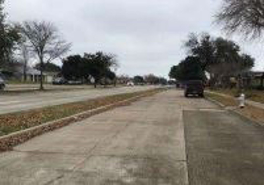 5052 South Colony Boulevard The Colony, TX 75056 - Photo 9 of 9 a view of a yard with a car parked on the road