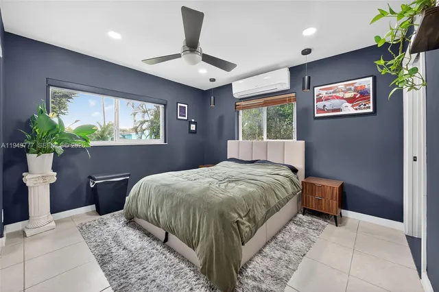 a bed sitting in a spacious bedroom next to a window