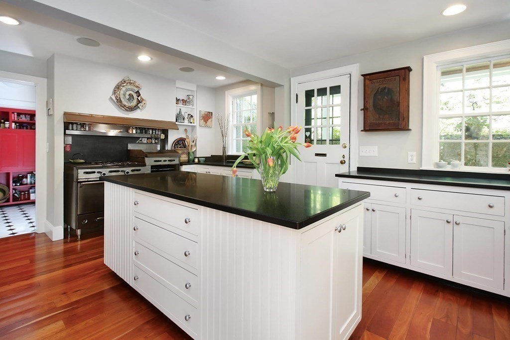156 Carlton Road Newton, MA 02468 - Photo 3 of 23 a kitchen with stainless steel appliances granite countertop a sink and a stove
