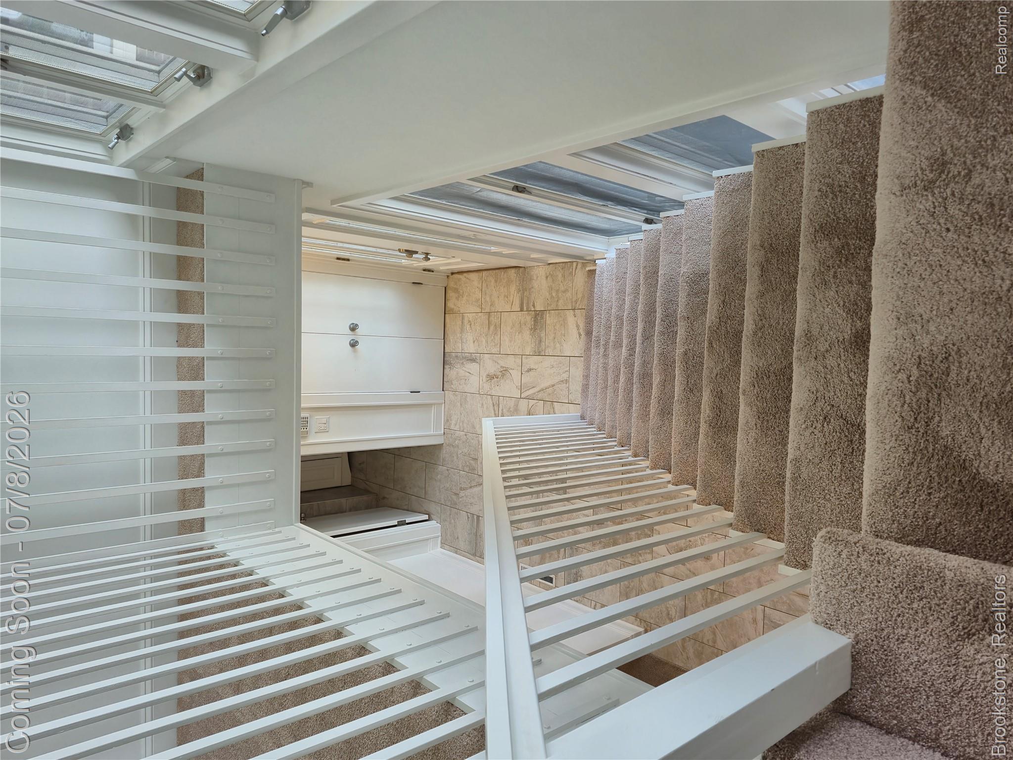 4140 South Henderson Road Davison, MI 48423 - Photo 70 of 98 Carpeted staircase with white balusters leading to a tiled entry