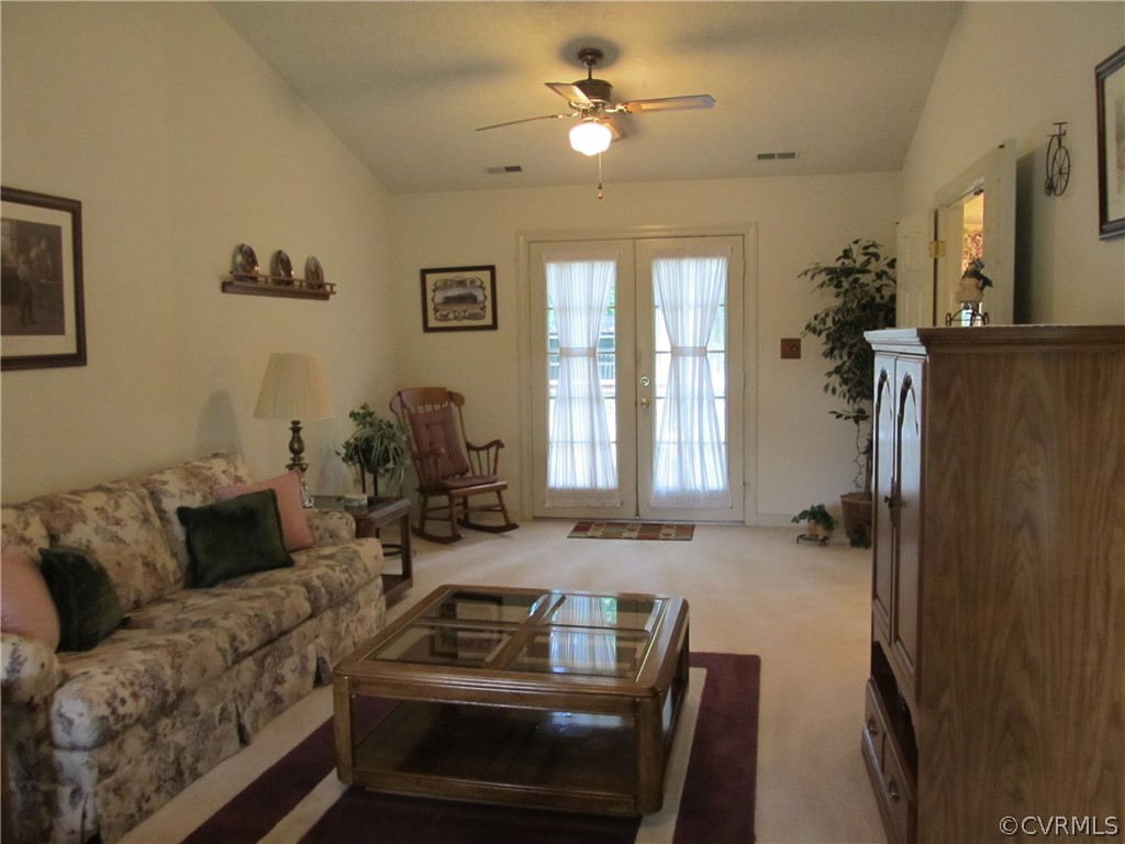 11018 Rufford Road Chester, VA 23831 - Photo 13 of 23 a living room with furniture a chandelier and a window