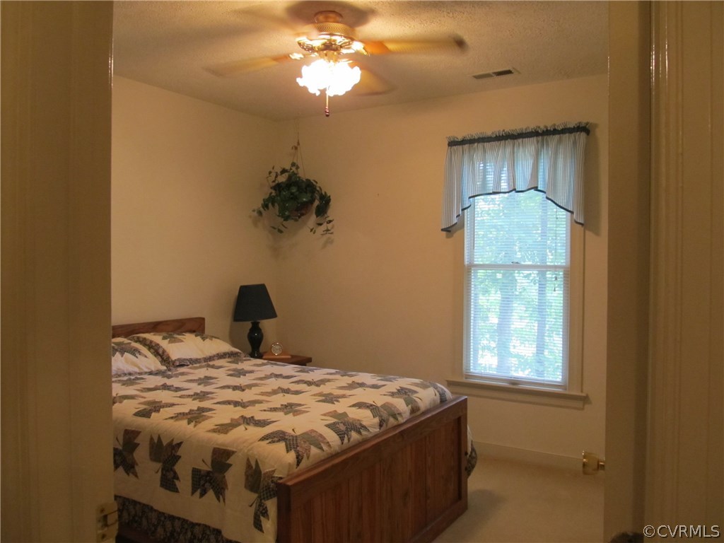 11018 Rufford Road Chester, VA 23831 - Photo 17 of 23 a bedroom with a bed and a window