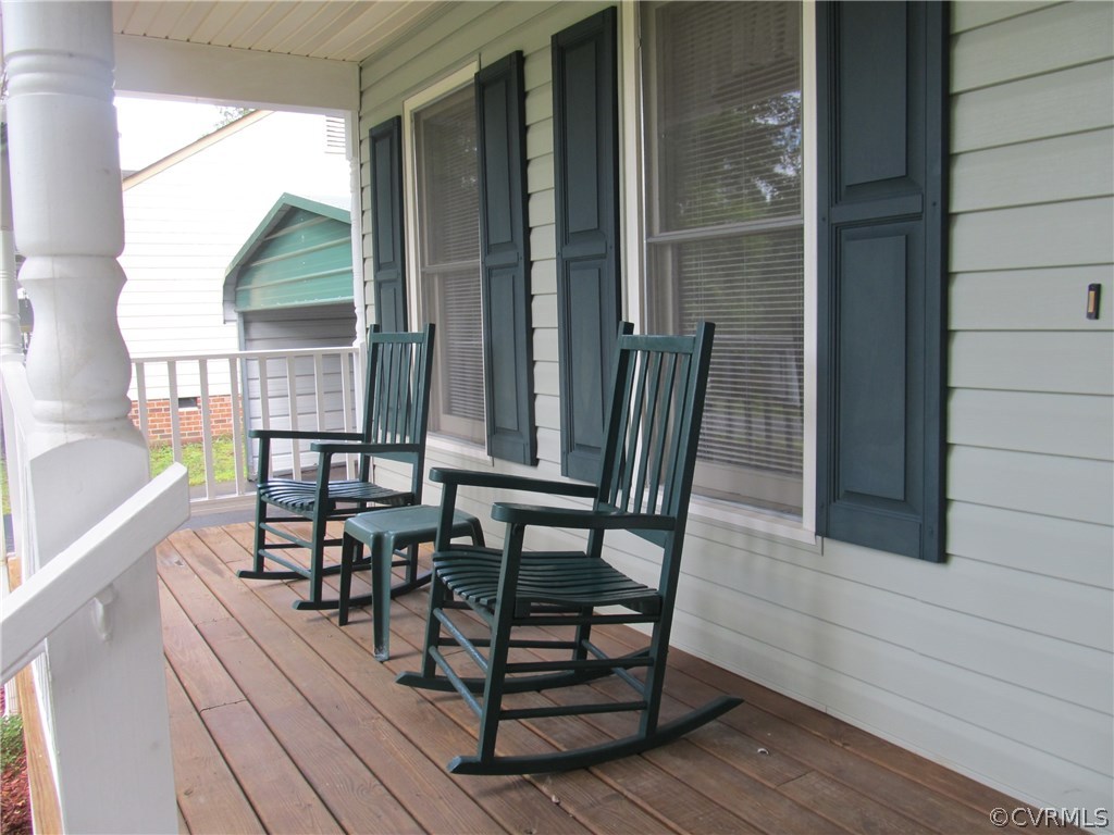 11018 Rufford Road Chester, VA 23831 - Photo 4 of 23 a view of a roof deck with table and chairs and wooden floor