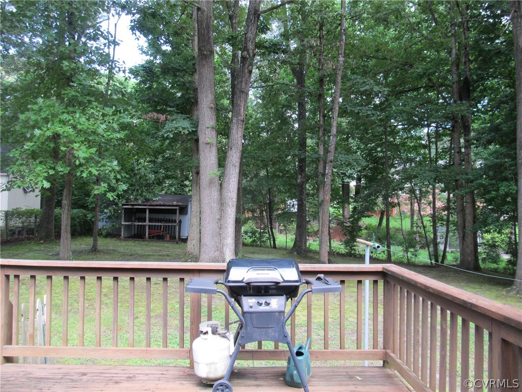11018 Rufford Road Chester, VA 23831 - Photo 6 of 23 a view of a deck with two chair and a potted plant