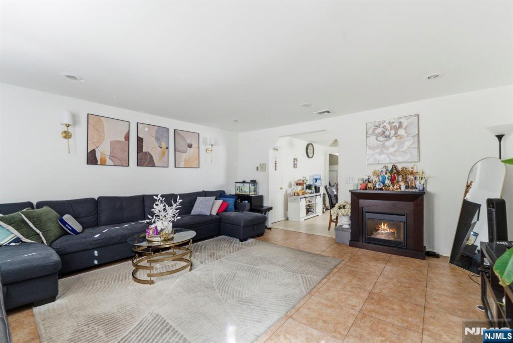 270 Westervelt Place Lodi, NJ 07644 - Photo 2 of 17 a living room with furniture a fireplace and a flat screen tv