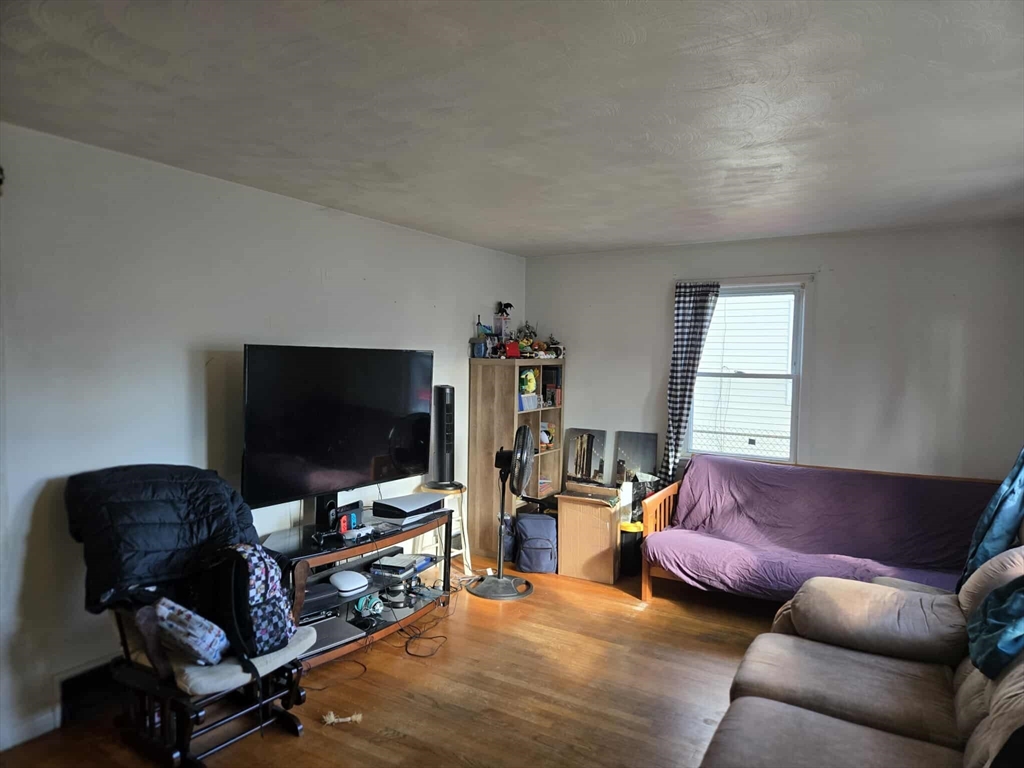 78 San Miguel Street Springfield, MA 01104 - Photo 13 of 26 a living room with furniture and a flat screen tv