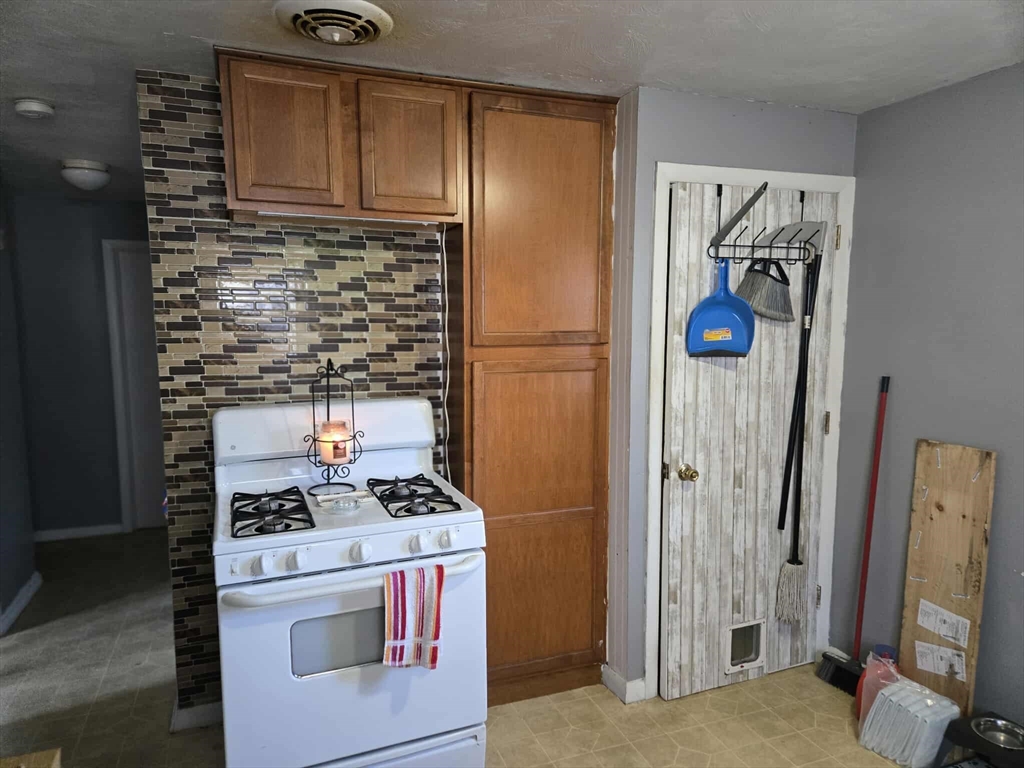 78 San Miguel Street Springfield, MA 01104 - Photo 20 of 26 a kitchen with a refrigerator and a stove
