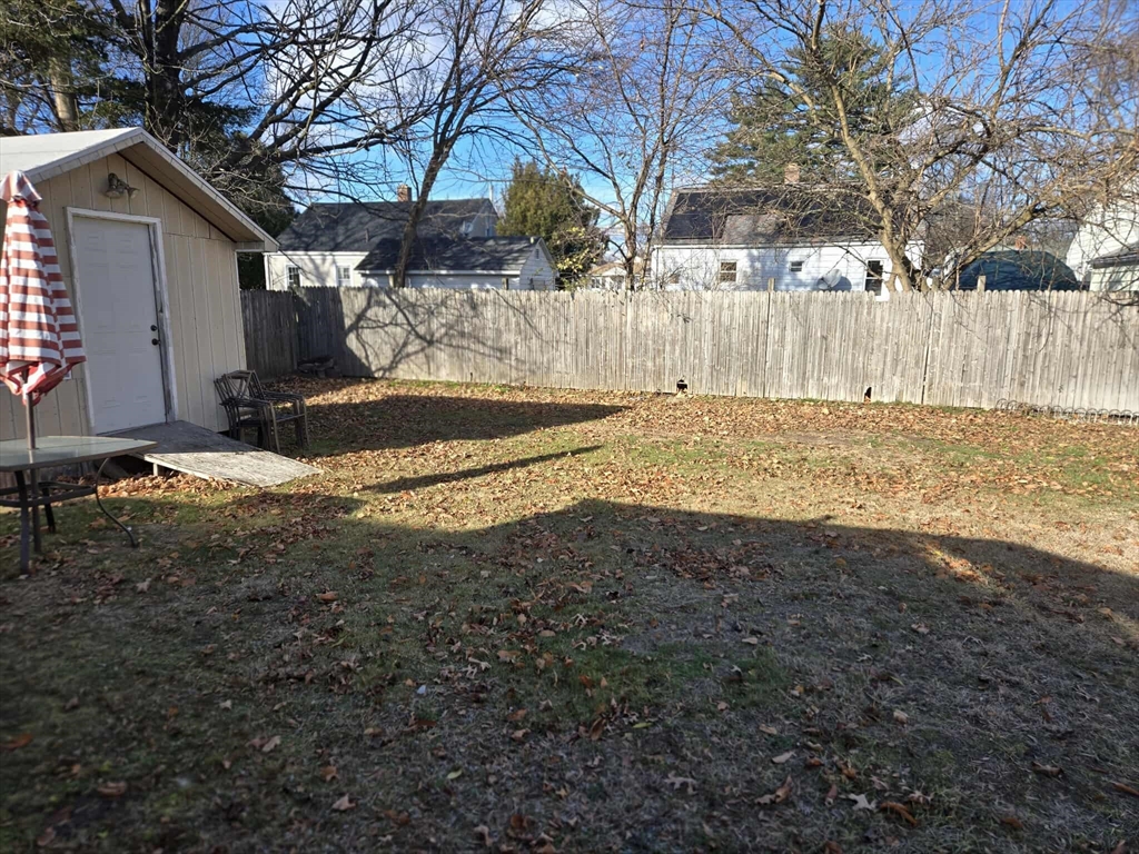 78 San Miguel Street Springfield, MA 01104 - Photo 4 of 26 a view of a yard with wooden fence