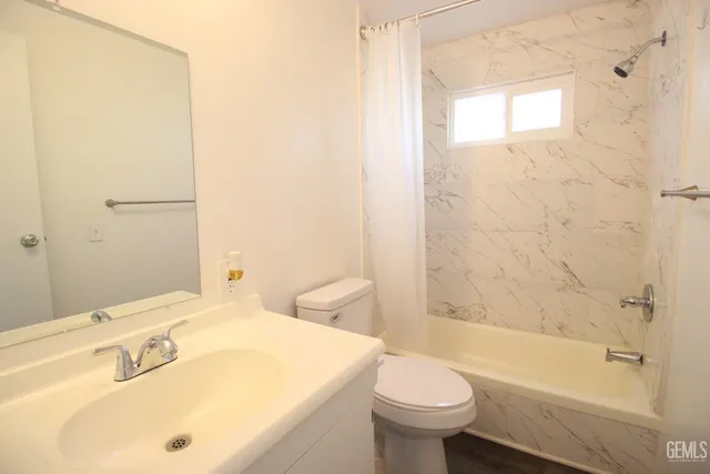 a bathroom with a sink mirror toilet and bathtub