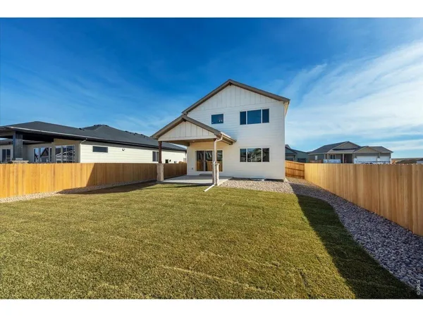 a house view with swimming pool in front of it