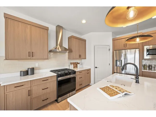 a kitchen with a stove a sink and a cabinets