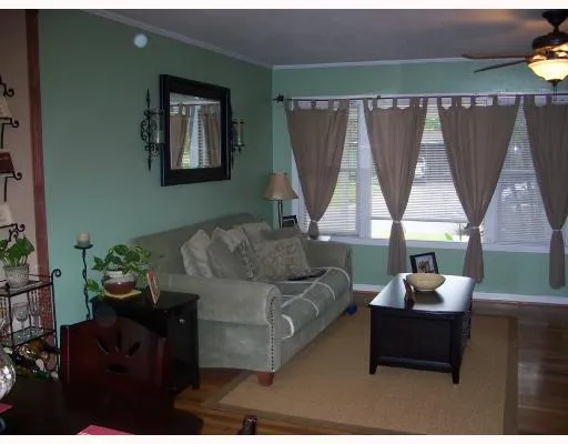 a living room with furniture a window and a flat screen tv