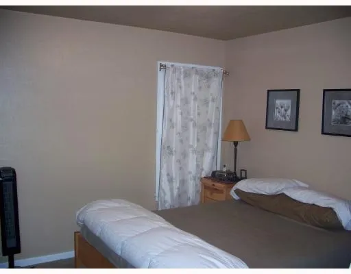 a bedroom with a bed and a lamp