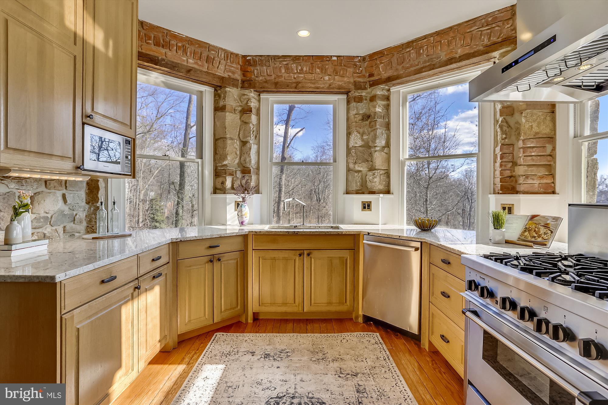 5417 Mohican Road Bethesda, MD 20816 - Photo 15 of 100 a large kitchen with stainless steel appliances granite countertop a stove a sink and a microwave