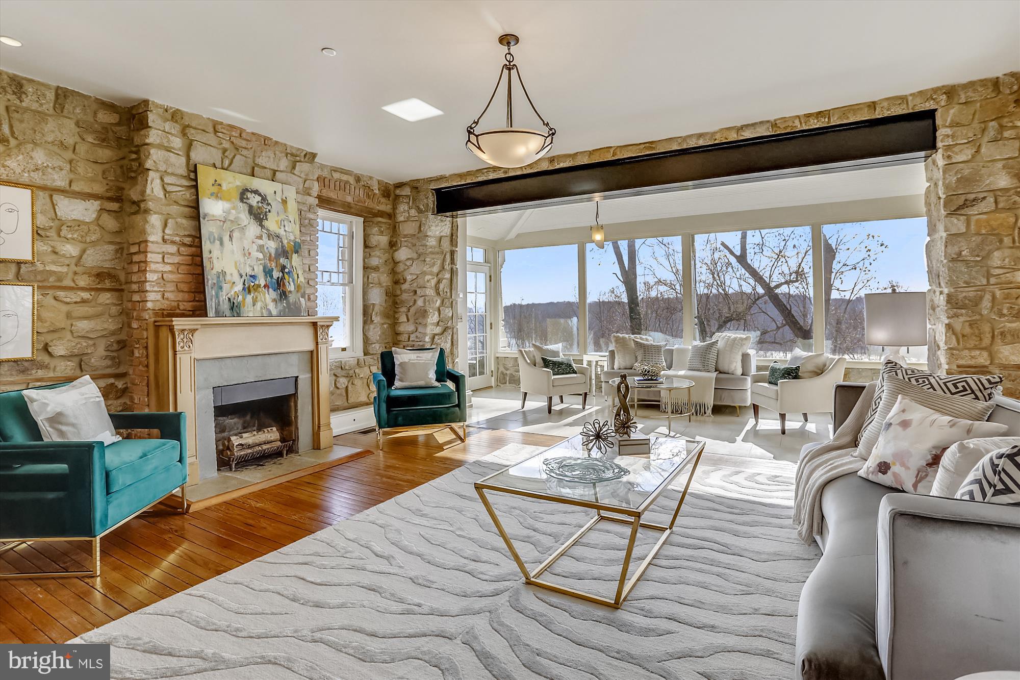 5417 Mohican Road Bethesda, MD 20816 - Photo 25 of 100 a living room with furniture a fireplace and floor to ceiling windows