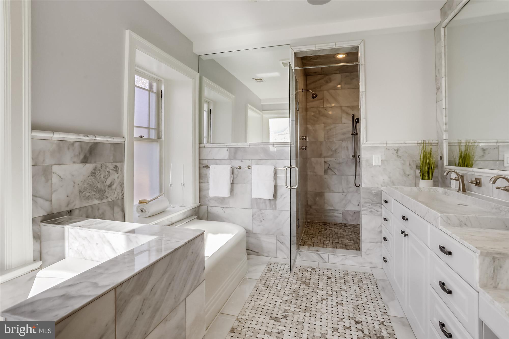 5417 Mohican Road Bethesda, MD 20816 - Photo 48 of 100 a bathroom with a granite countertop sink a mirror a shower and a bathtub