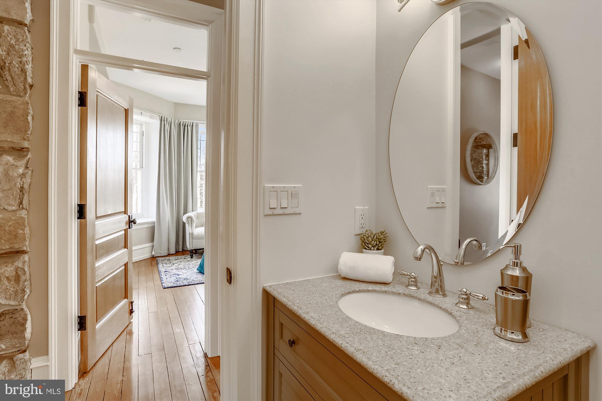 5417 Mohican Road Bethesda, MD 20816 - Photo 55 of 100 a bathroom with a granite countertop sink and a mirror
