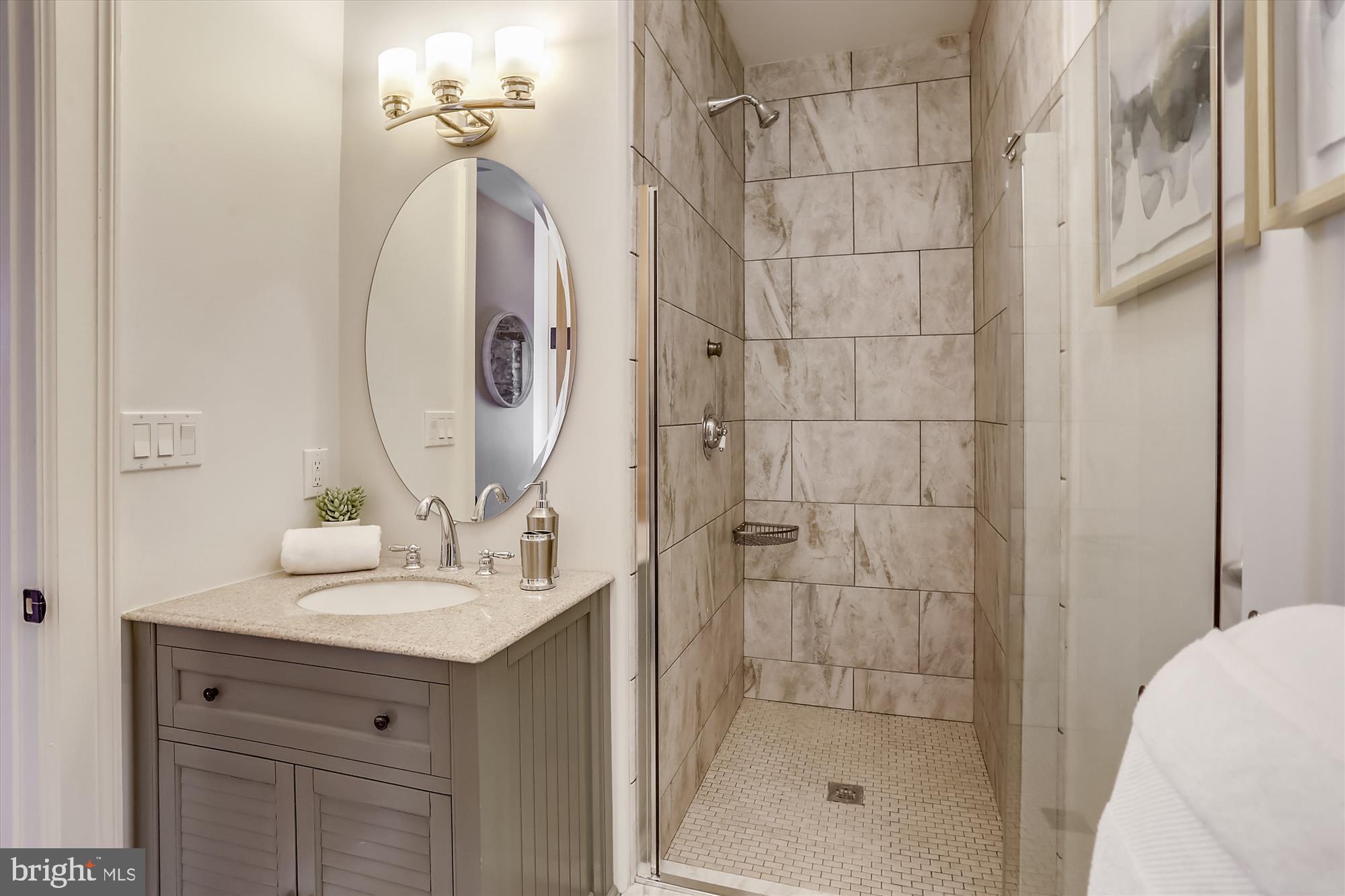5417 Mohican Road Bethesda, MD 20816 - Photo 56 of 100 a bathroom with a sink vanity granite and shower