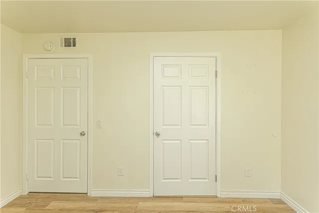 an empty room with wooden floor