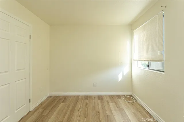 a view of a room with wooden floor and brick walls