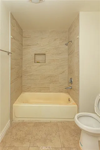 a bathroom with a toilet and bathtub