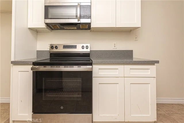 a stove top oven sitting inside of a kitchen