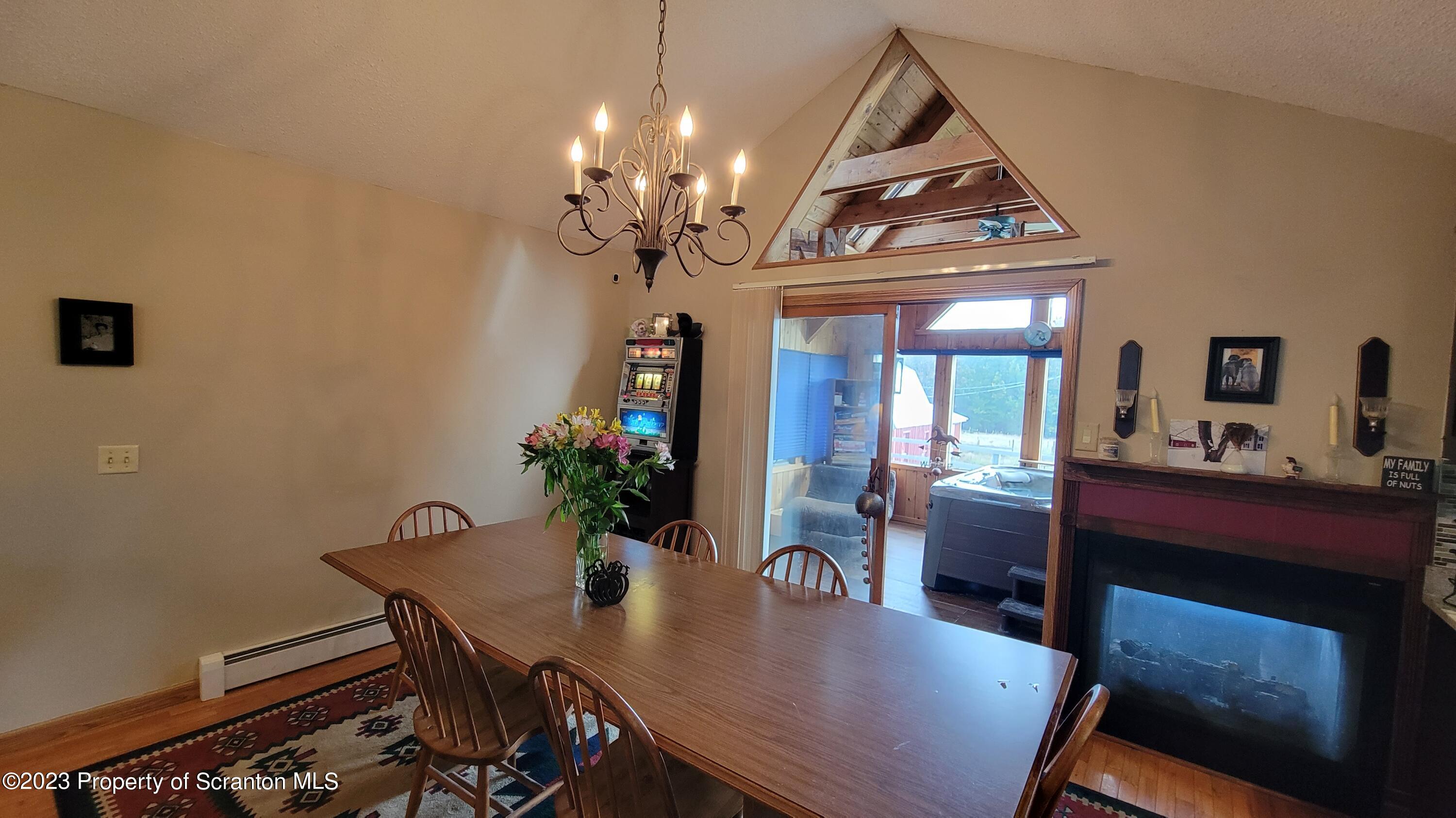 618 Kennedy Road Brackney, PA 18812 - Photo 14 of 35 a view of a dining room with furniture and chandelier