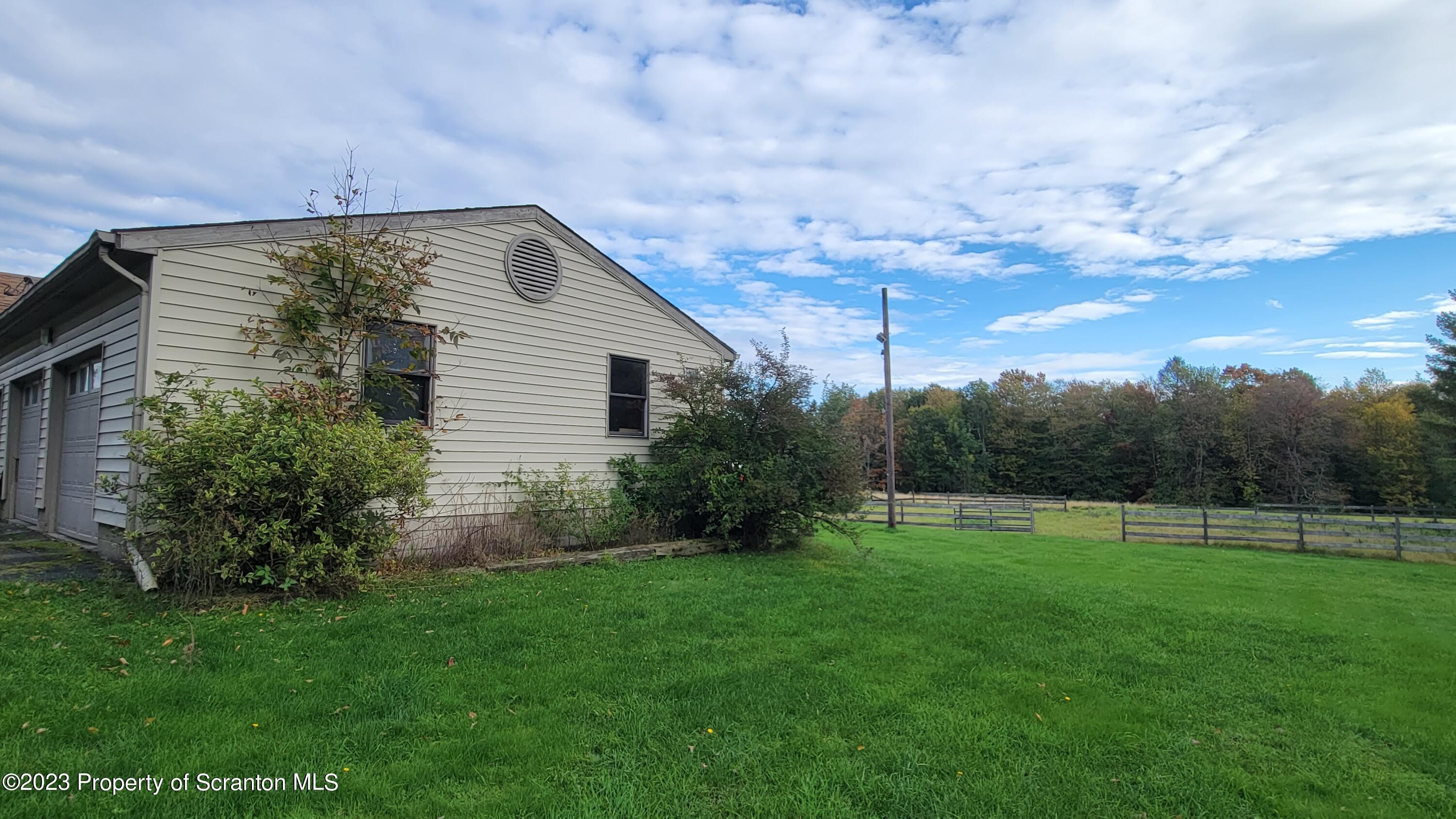 618 Kennedy Road Brackney, PA 18812 - Photo 4 of 35 a backyard of a house with lots of green space