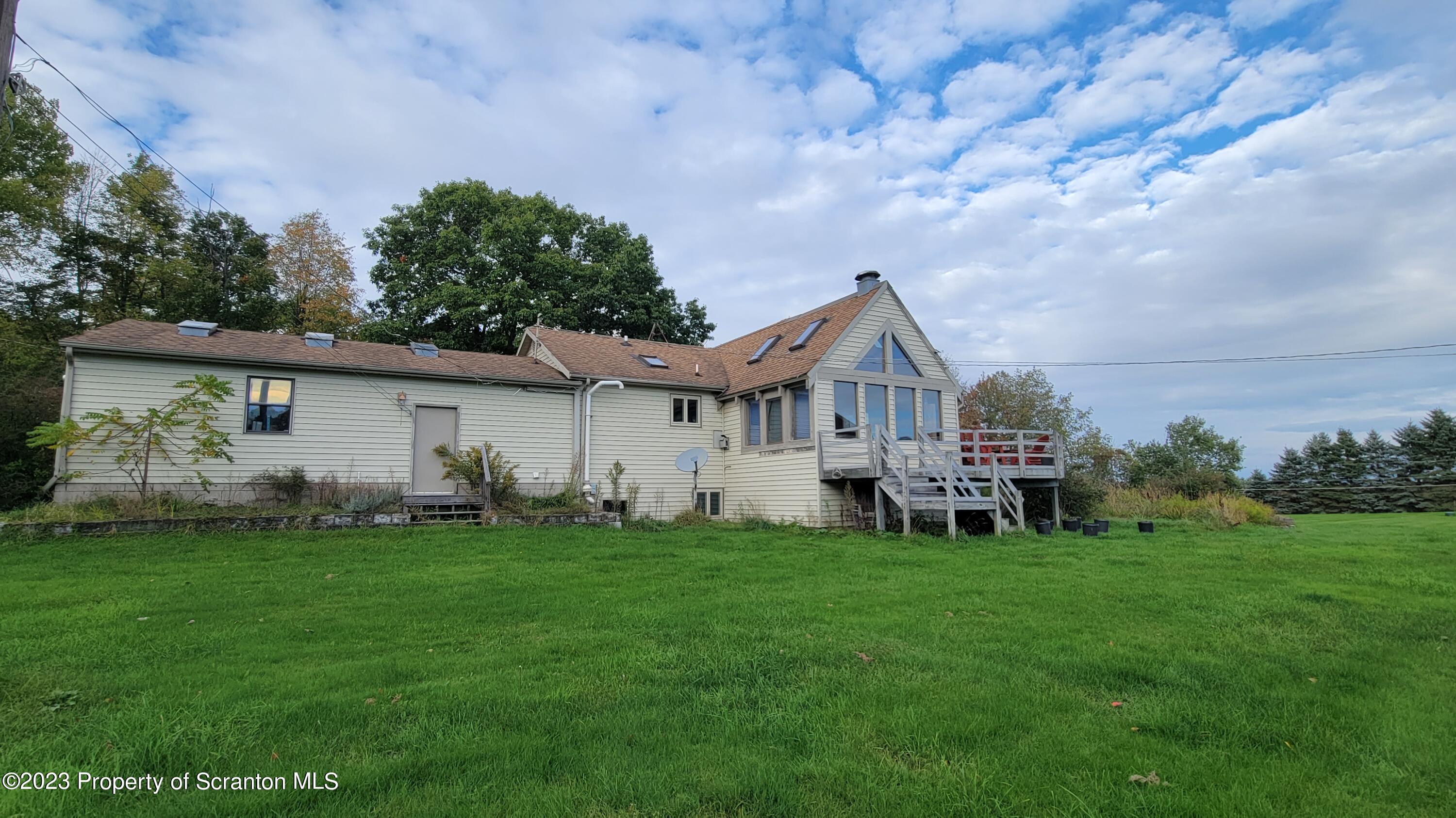 618 Kennedy Road Brackney, PA 18812 - Photo 5 of 35 a view of a house with a yard and deck