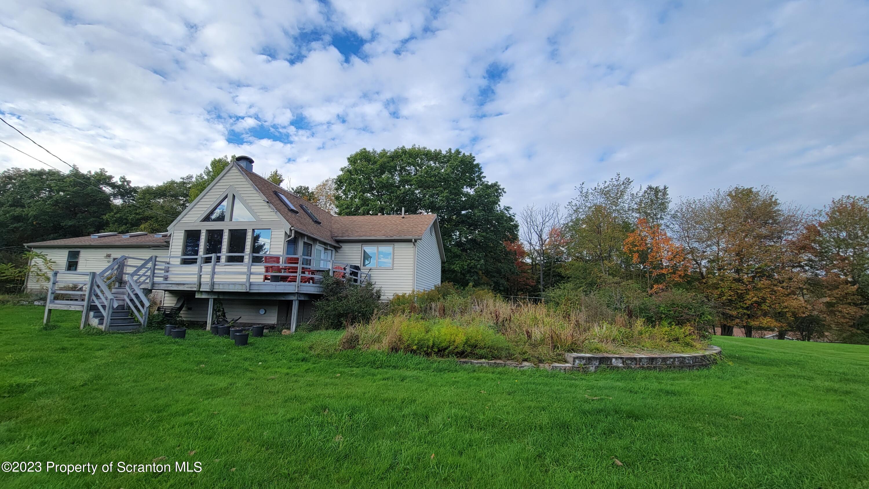618 Kennedy Road Brackney, PA 18812 - Photo 6 of 35 a front view of a house with garden