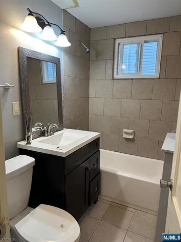a bathroom with a sink a toilet and bathtub