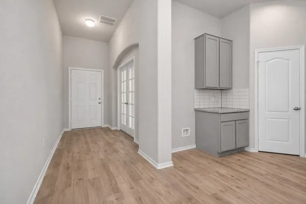 a view of kitchen with granite countertop cabinets and wooden floor