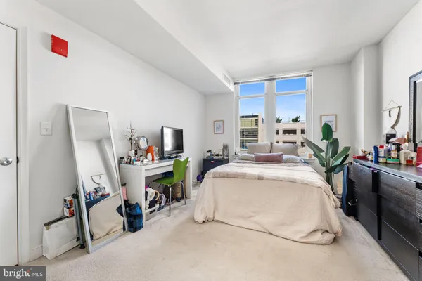 a bed room with a bed and a chair