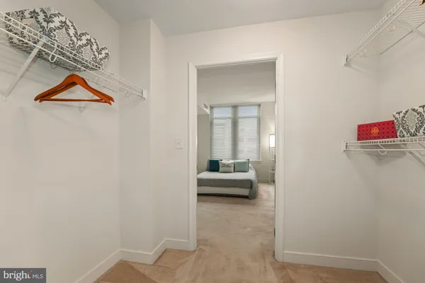 a bed room with a bed and a flat tv screen