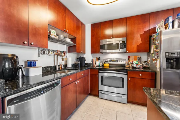 a kitchen with stainless steel appliances granite countertop a stove and a sink