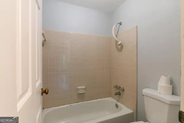 a bathroom with a bathtub and a toilet