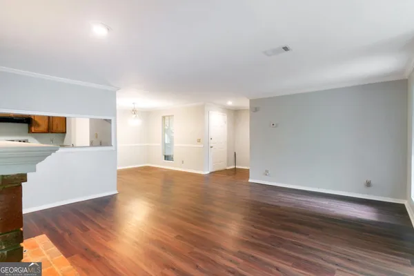 a view of a kitchen with wooden floor and a sink