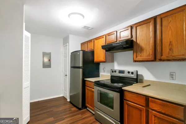 a kitchen with stainless steel appliances granite countertop a stove a refrigerator and a microwave