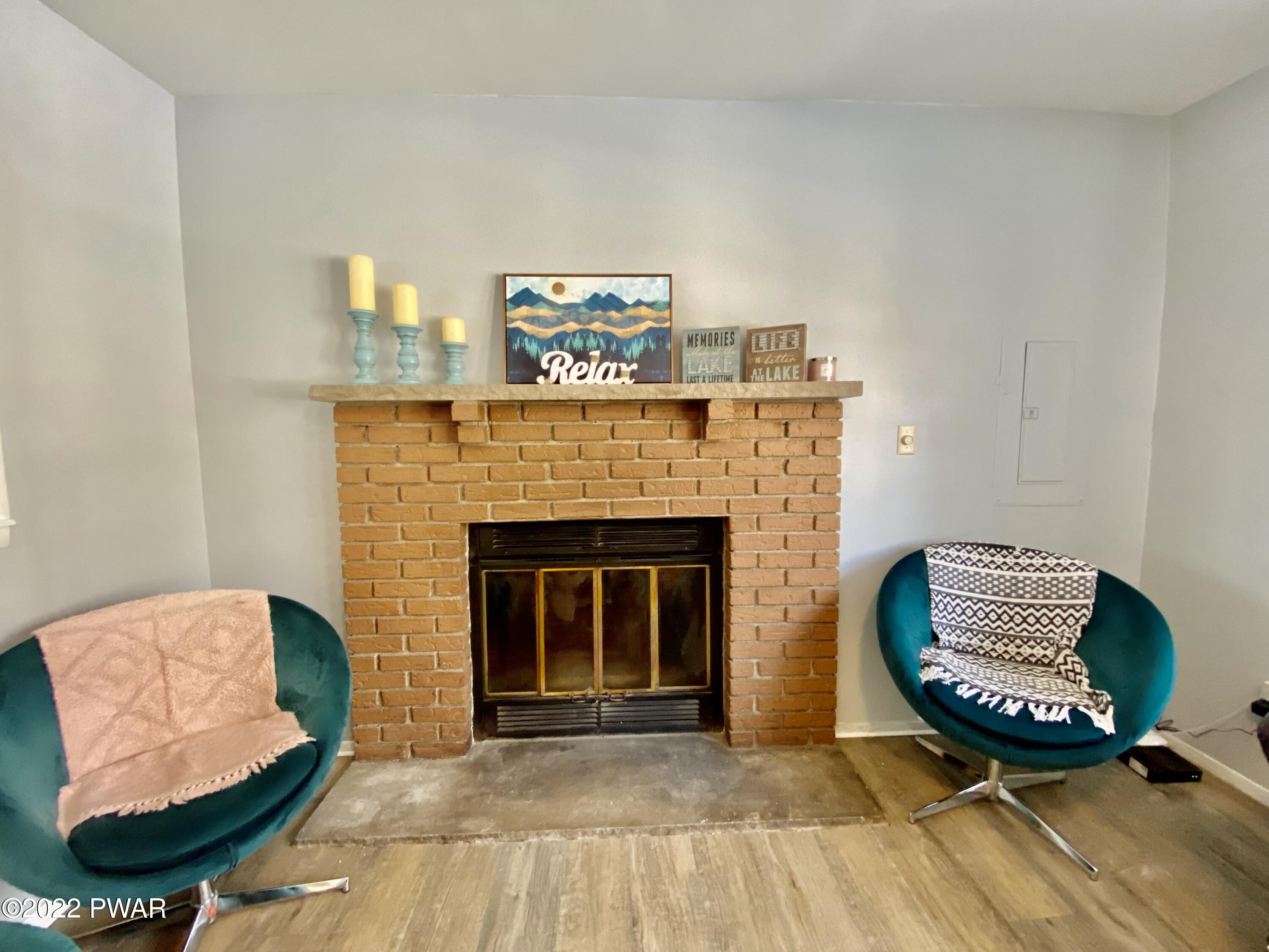 126 Roundhill Road Dingmans Ferry, PA 18328 - Photo 7 of 30 a living room with furniture and a fireplace