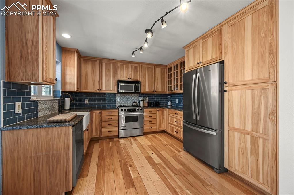 284 County Road 511 Divide, CO 80814 - Photo 13 of 49 a kitchen with granite countertop stainless steel appliances a refrigerator cabinets and wooden floor