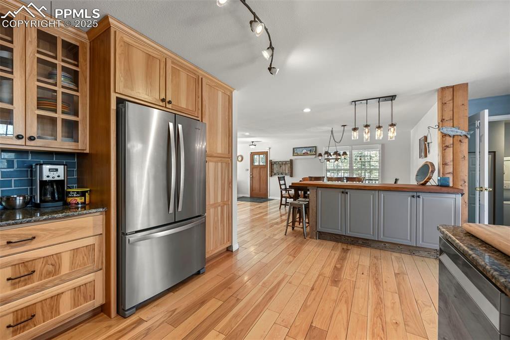 284 County Road 511 Divide, CO 80814 - Photo 14 of 49 a kitchen with stainless steel appliances a refrigerator and wooden cabinets