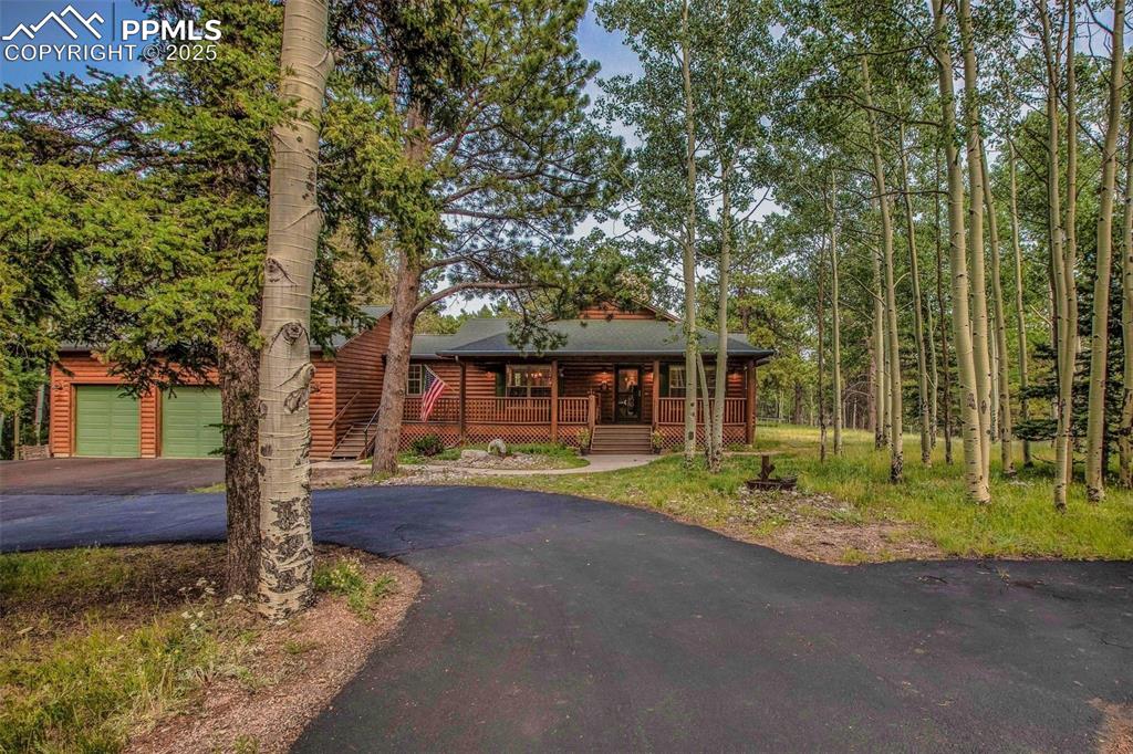 284 County Road 511 Divide, CO 80814 - Photo 3 of 49 a front view of a house with garden
