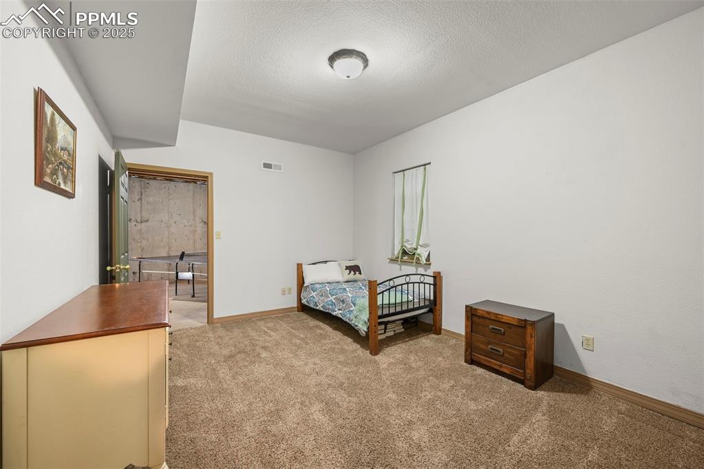 284 County Road 511 Divide, CO 80814 - Photo 33 of 49 a spacious bedroom with a bed and a table in it