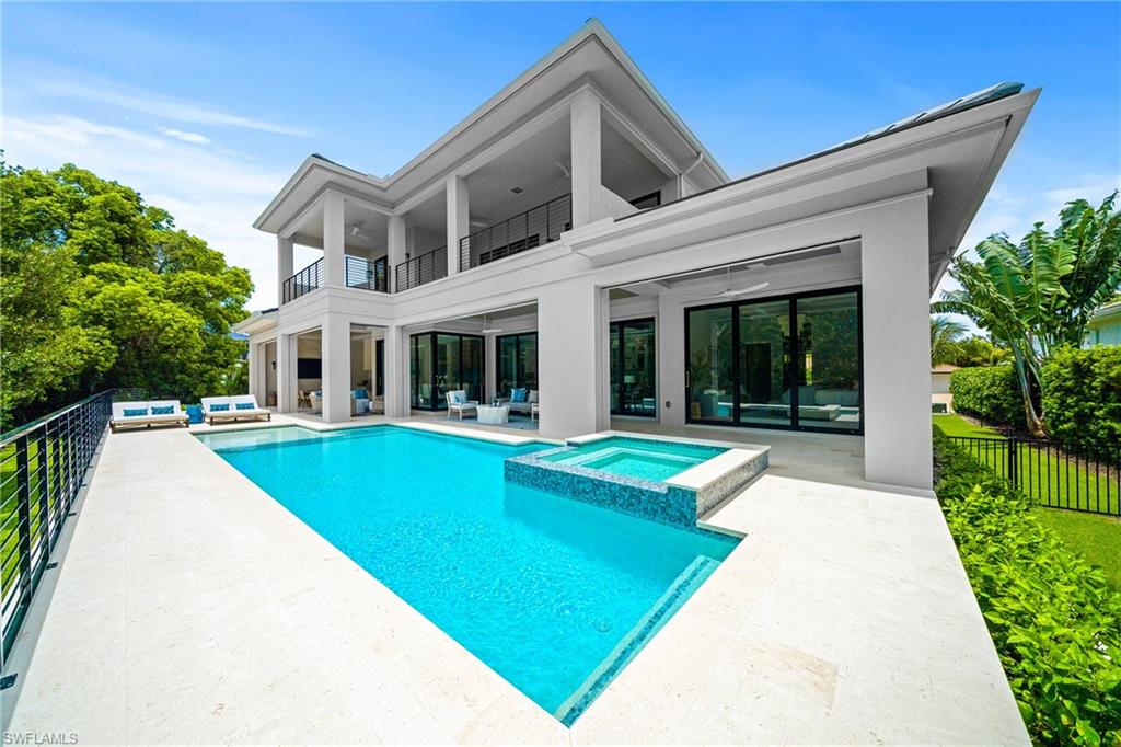 448 Devils Lane Naples, FL 34103 - Photo 11 of 15 a view of house with swimming pool and porch