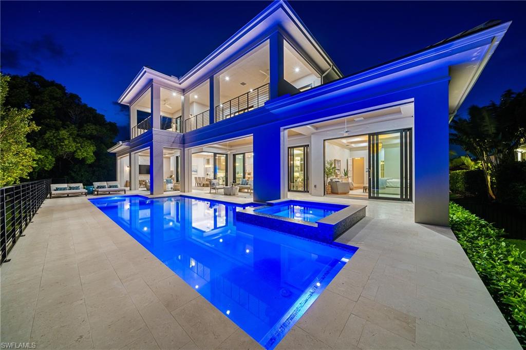 448 Devils Lane Naples, FL 34103 - Photo 12 of 15 a view of a house with pool and sitting area