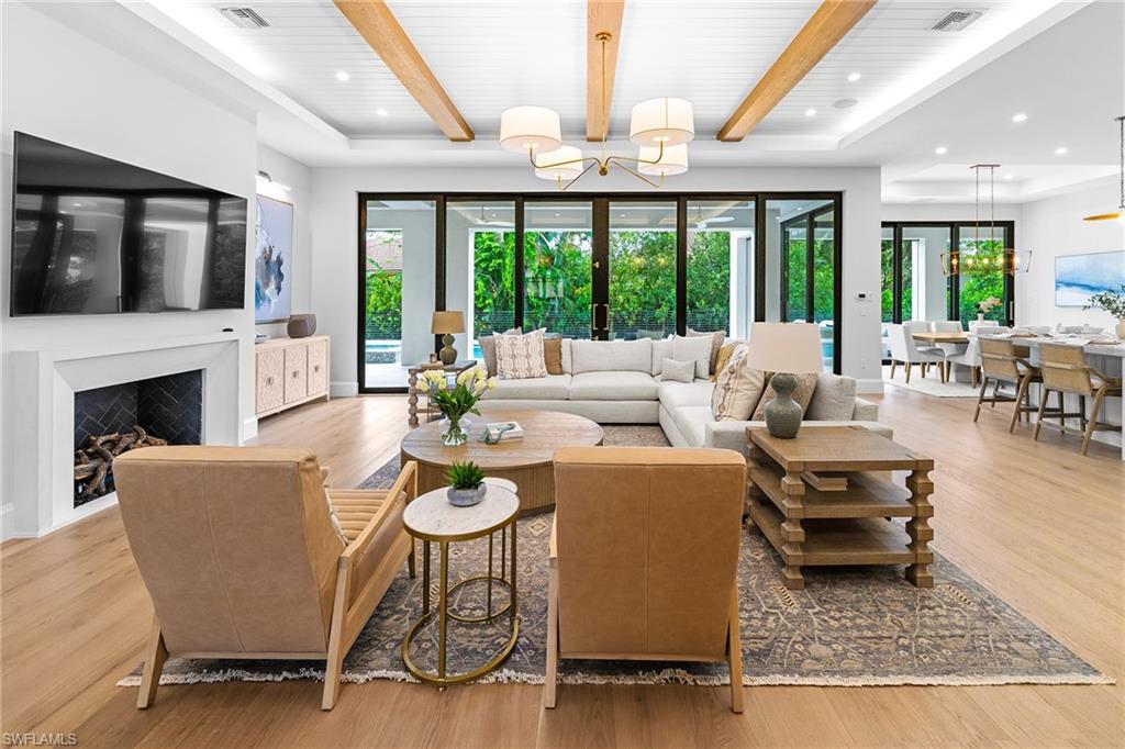 448 Devils Lane Naples, FL 34103 - Photo 3 of 15 a living room with furniture fireplace and large windows