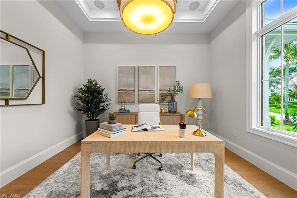 448 Devils Lane Naples, FL 34103 - Photo 9 of 15 a view of a room that has a table and a chair in it