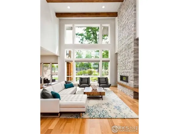 a living room with furniture a rug and a fireplace