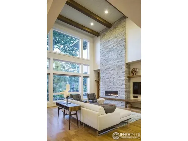 a living room with furniture and large windows